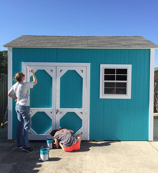 Couple painting their shed